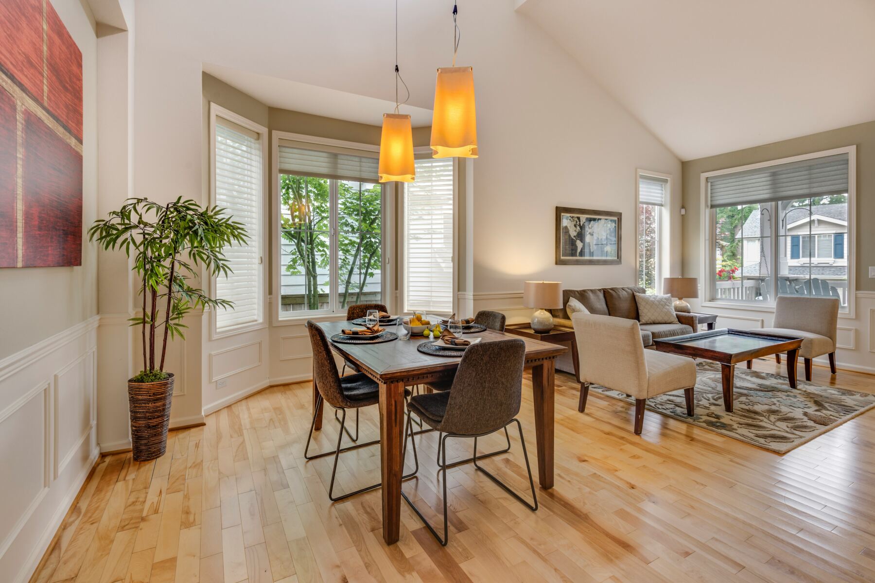 Sunny dining room with hardwood floors and bay windows