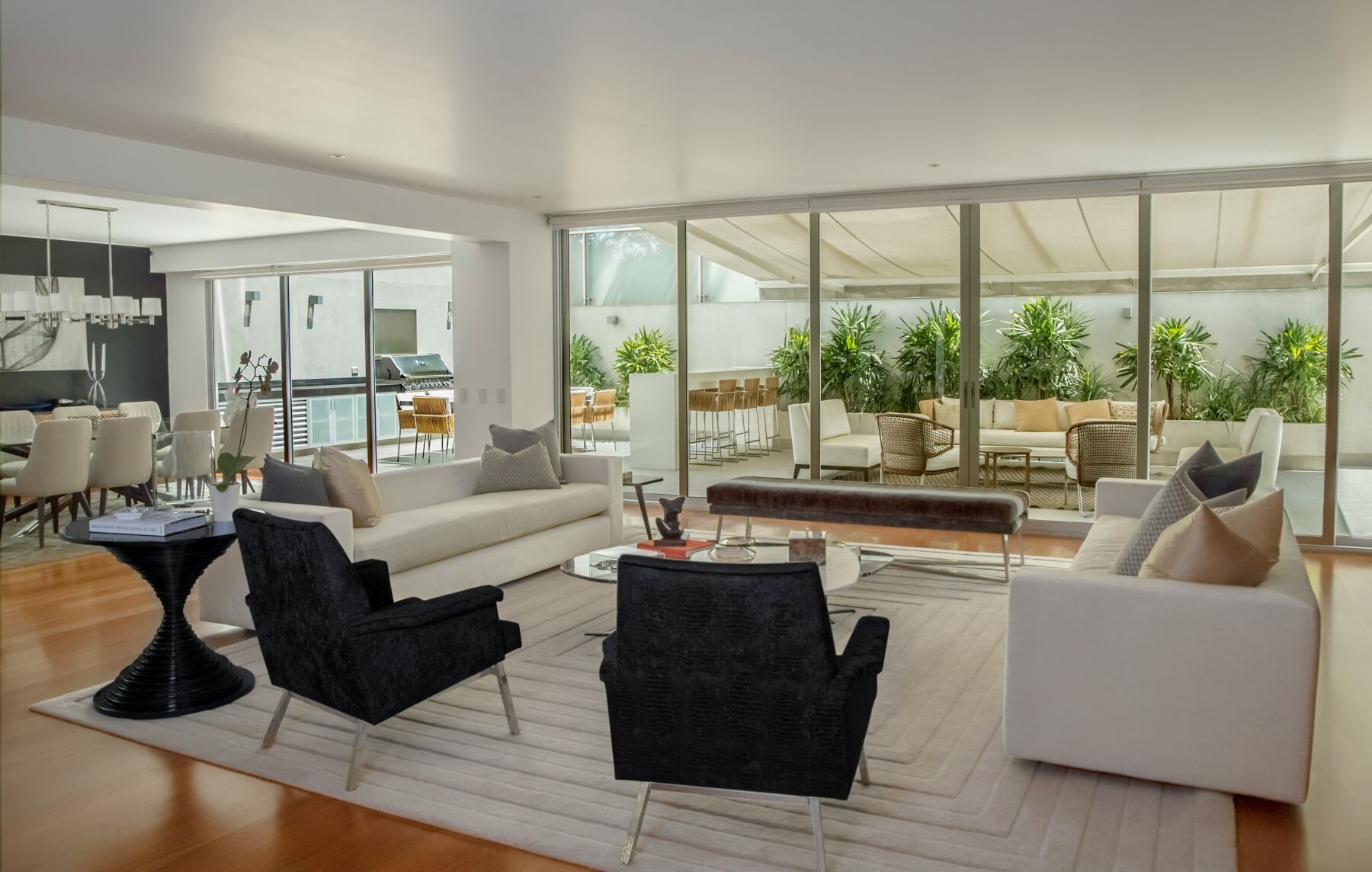 Open living room with floor-to-ceiling glass doors